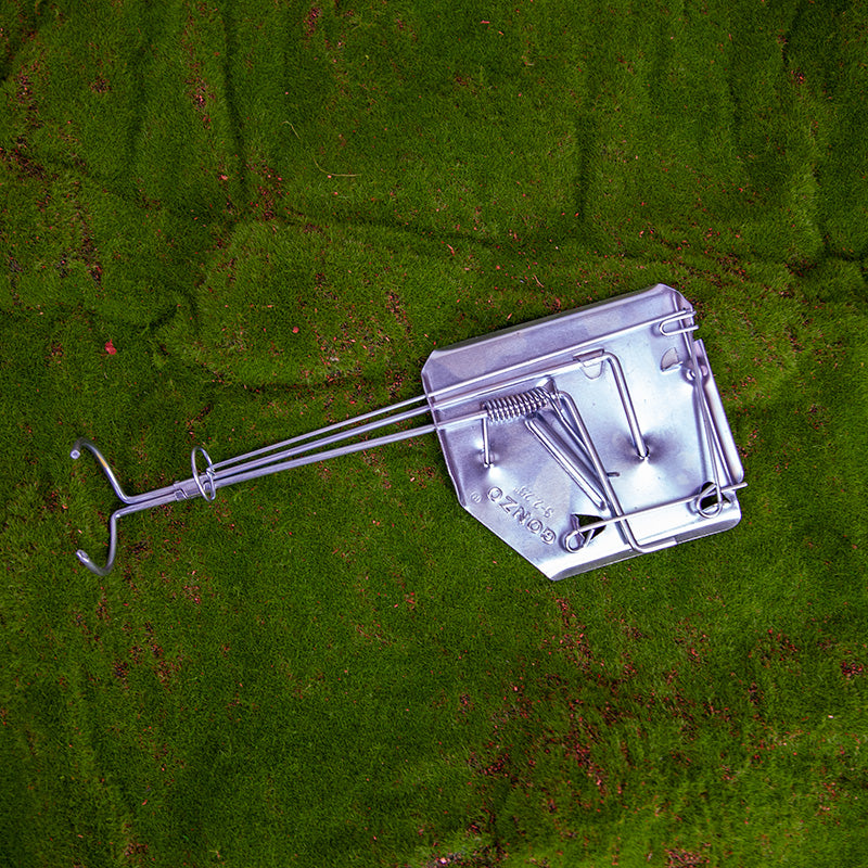 SureFire Gopher Trap photo on a grassy background - trap open