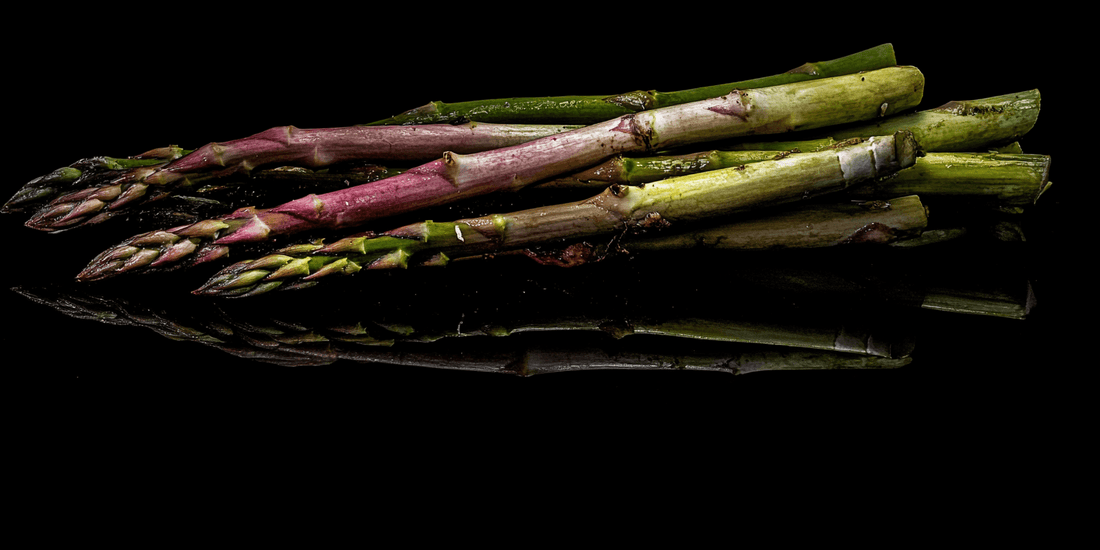 Bundle of green and purple asparagus spears