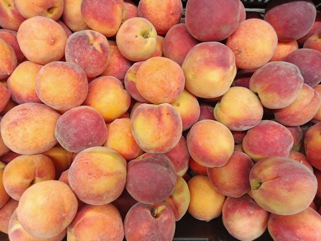 Ripe peaches displayed at a market