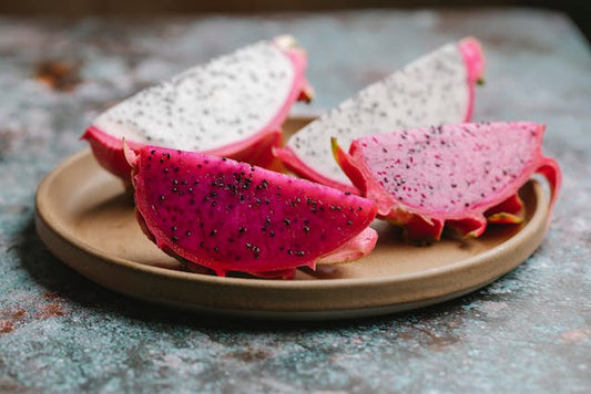 Fresh Slices of Dragon Fruit on Wooden Plate