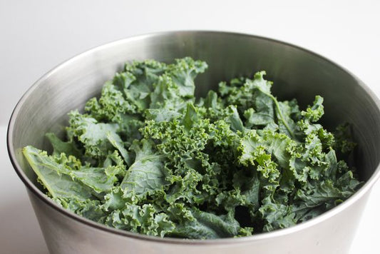 Healthy fresh kale leaves in a stainless steel bowl, perfect for salads and healthy meals