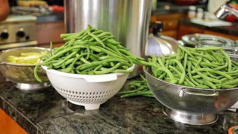 Bowls and colander filled with green beans