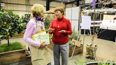 Two women discussing a gardening book at a store