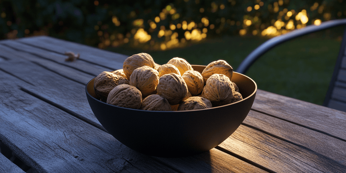 Walnuts in a black bowl on an outdoor table