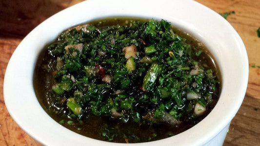 Bowl of dark green chimichurri sauce