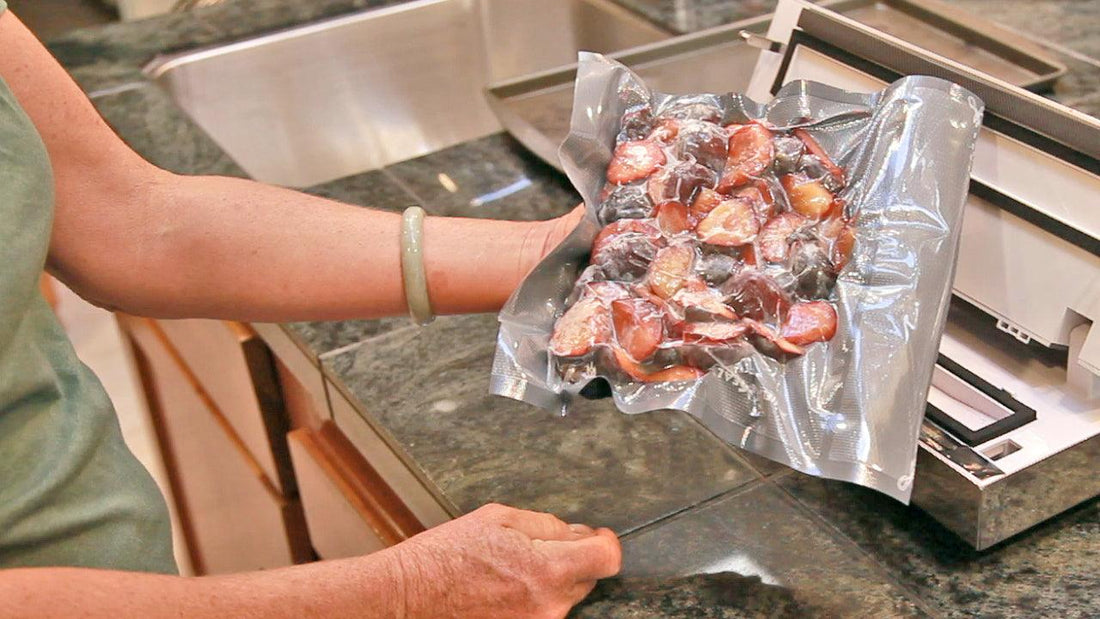 Vacuum-sealing berries in a clear freezer bag