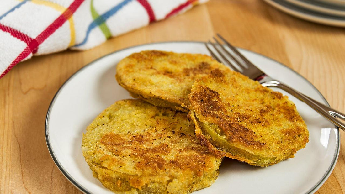 Three fried green tomato slices on a plate
