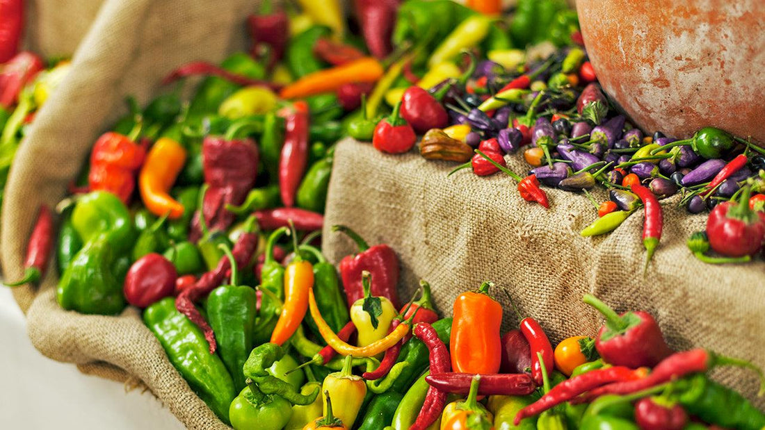 Assorted colorful peppers displayed in baskets