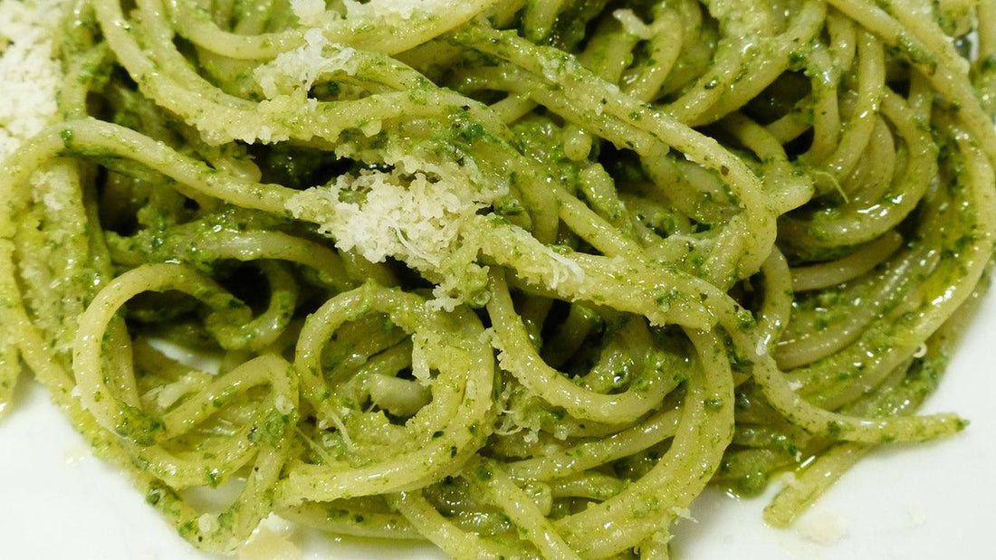 Bowl of spaghetti coated in spinach-sage pesto