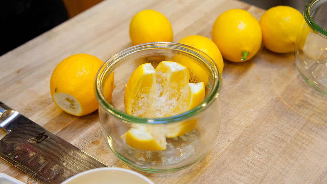 Jar of preserved citrus surrounded by lemons