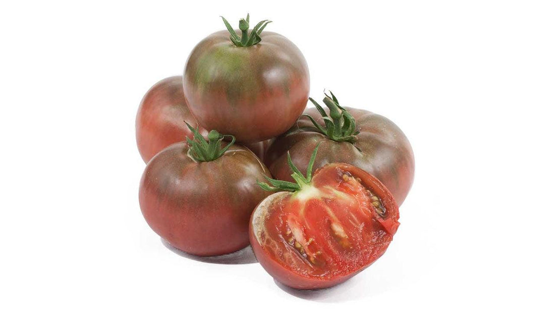Whole and cut dark red heirloom tomatoes