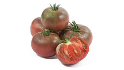 Whole and cut dark red heirloom tomatoes