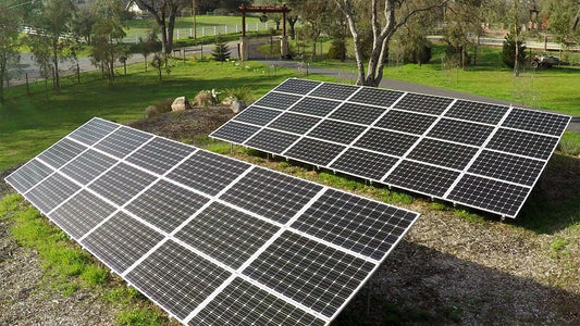 Rows of solar panels on a grassy slope
