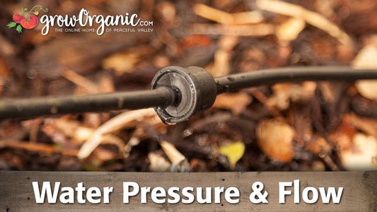 Inline drip emitter connected between black irrigation tubes