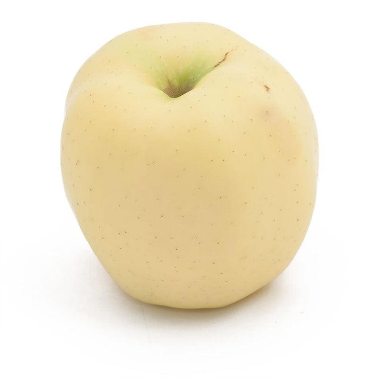 Single pale golden apple on white