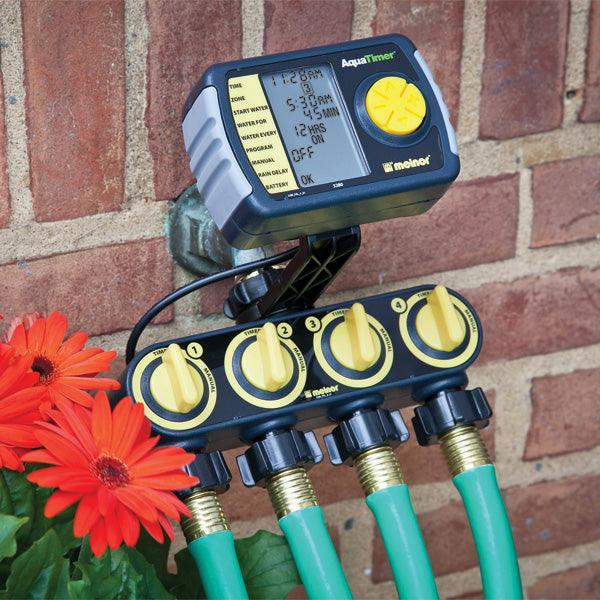 Electronic irrigation timer connected to four hoses