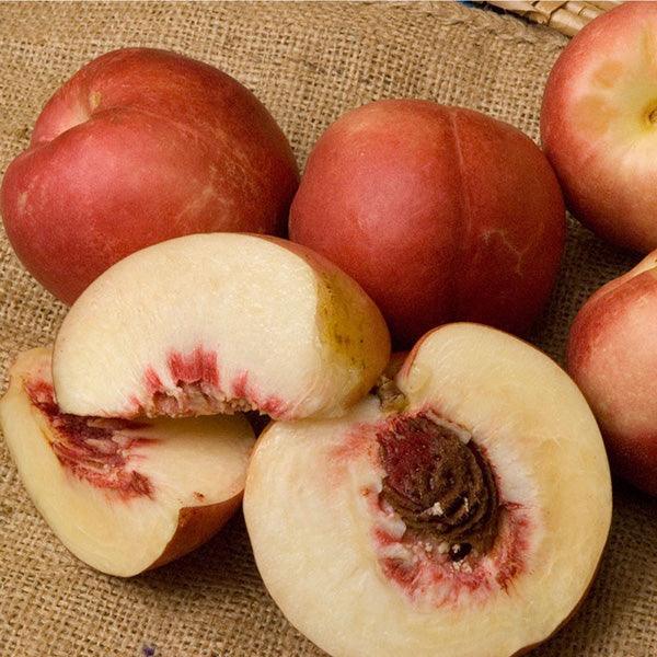 Whole and cut white-fleshed nectarines