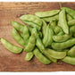 Thorogreen Lima Beans resting on a cutting board, pale green pods 