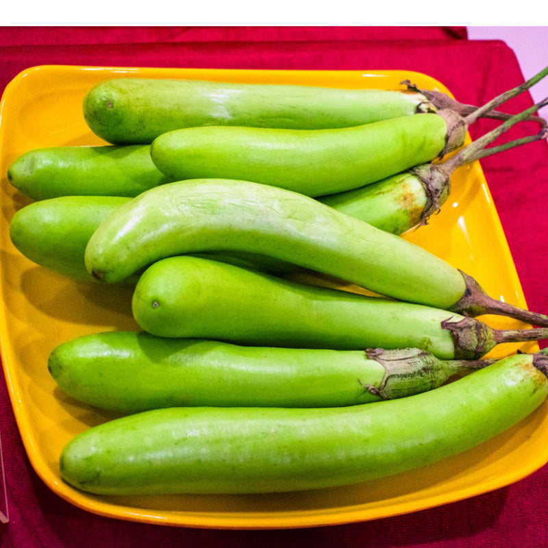A yellow plate of Elongated green eggplants 
