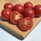 Fox Cherry Tomatoes resting on a wooden cutting board