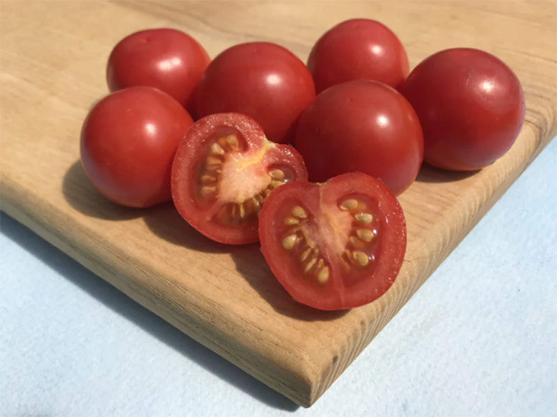 Fox Cherry Tomatoes resting on a wooden cutting board