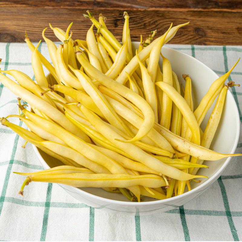 A white bowl full of Buerre de Rockencourt Wax Bush Bean, pale yellow in color 